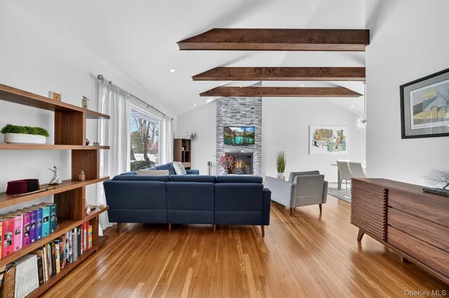 a living room with furniture large window and a fireplace