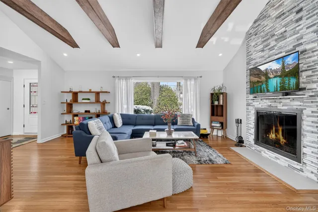 a living room with fireplace furniture and a flat screen tv