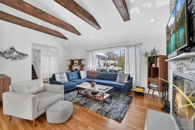 a living room with furniture or wooden floor and a chandelier