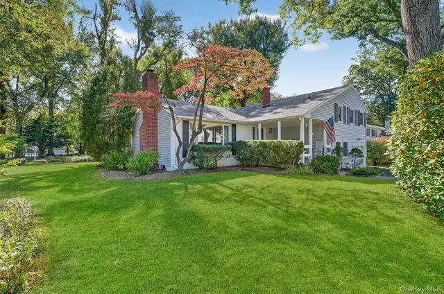 a front view of house with yard and green space