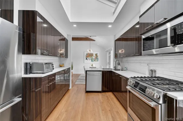 a kitchen with stainless steel appliances a refrigerator and a stove top oven