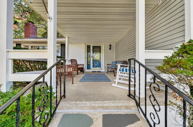 a view of a patio with a table and chairs and wooden floor