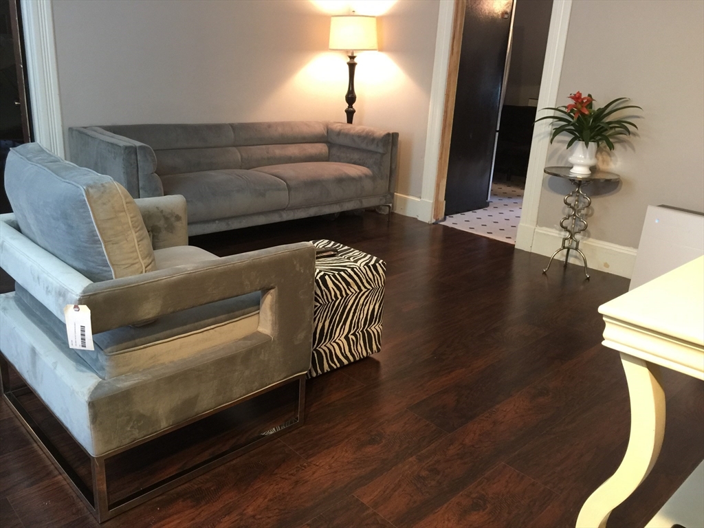 52 Warner Street Springfield, MA 01108 - Photo 1 of 8 a living room with furniture and a lamp