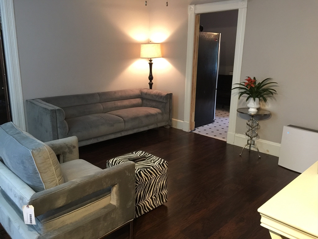 52 Warner Street Springfield, MA 01108 - Photo 5 of 8 a living room with furniture and a lamp