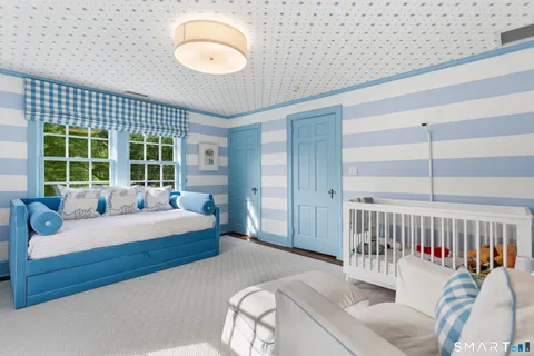 a bed room with a bed and a large window