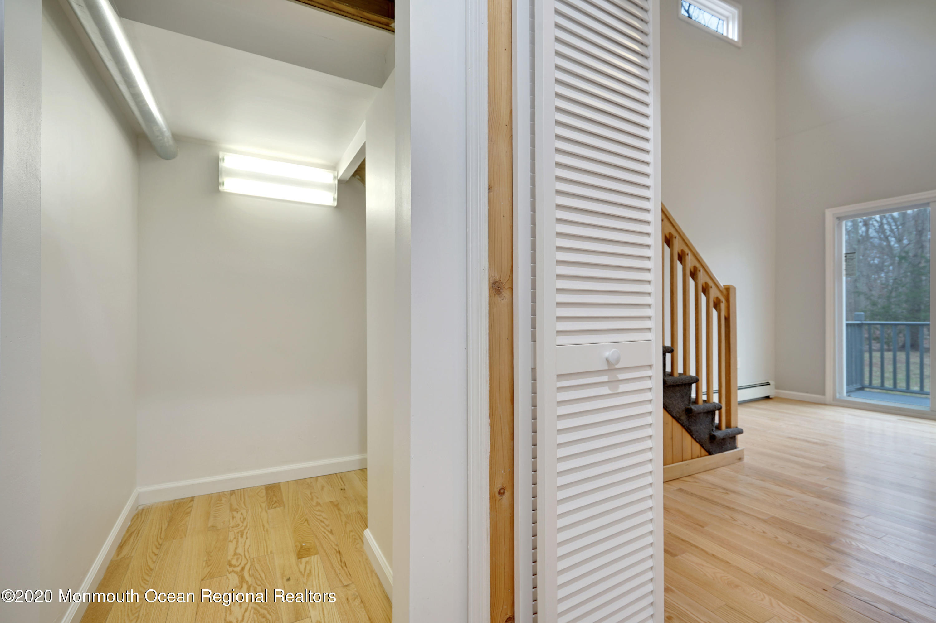 17 Helen Avenue Howell, NJ 07731 - Photo 26 of 67 a view of a hallway with wooden floor and a bathroom