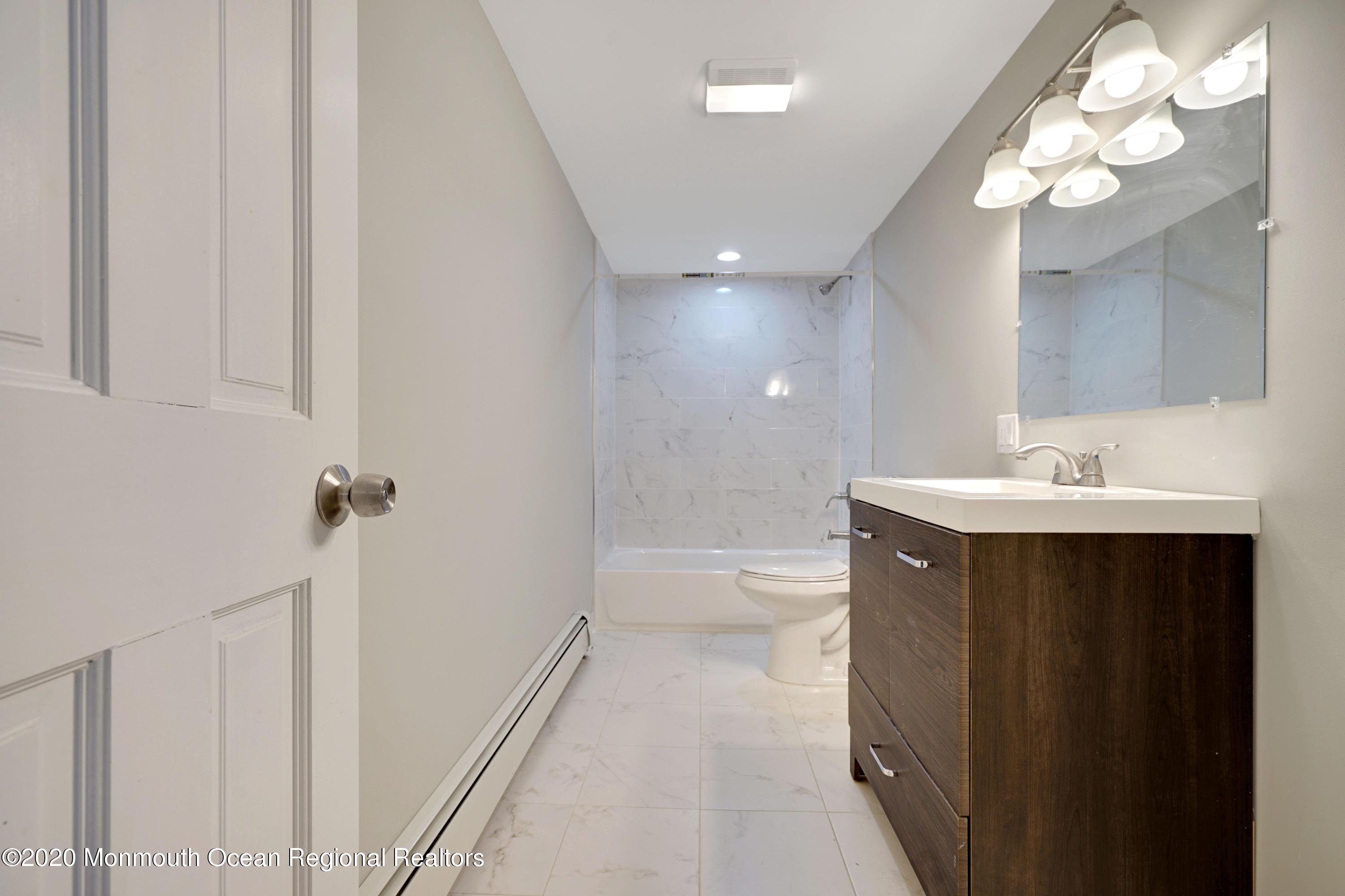 17 Helen Avenue Howell, NJ 07731 - Photo 29 of 67 a bathroom with a sink a toilet a mirror and vanity