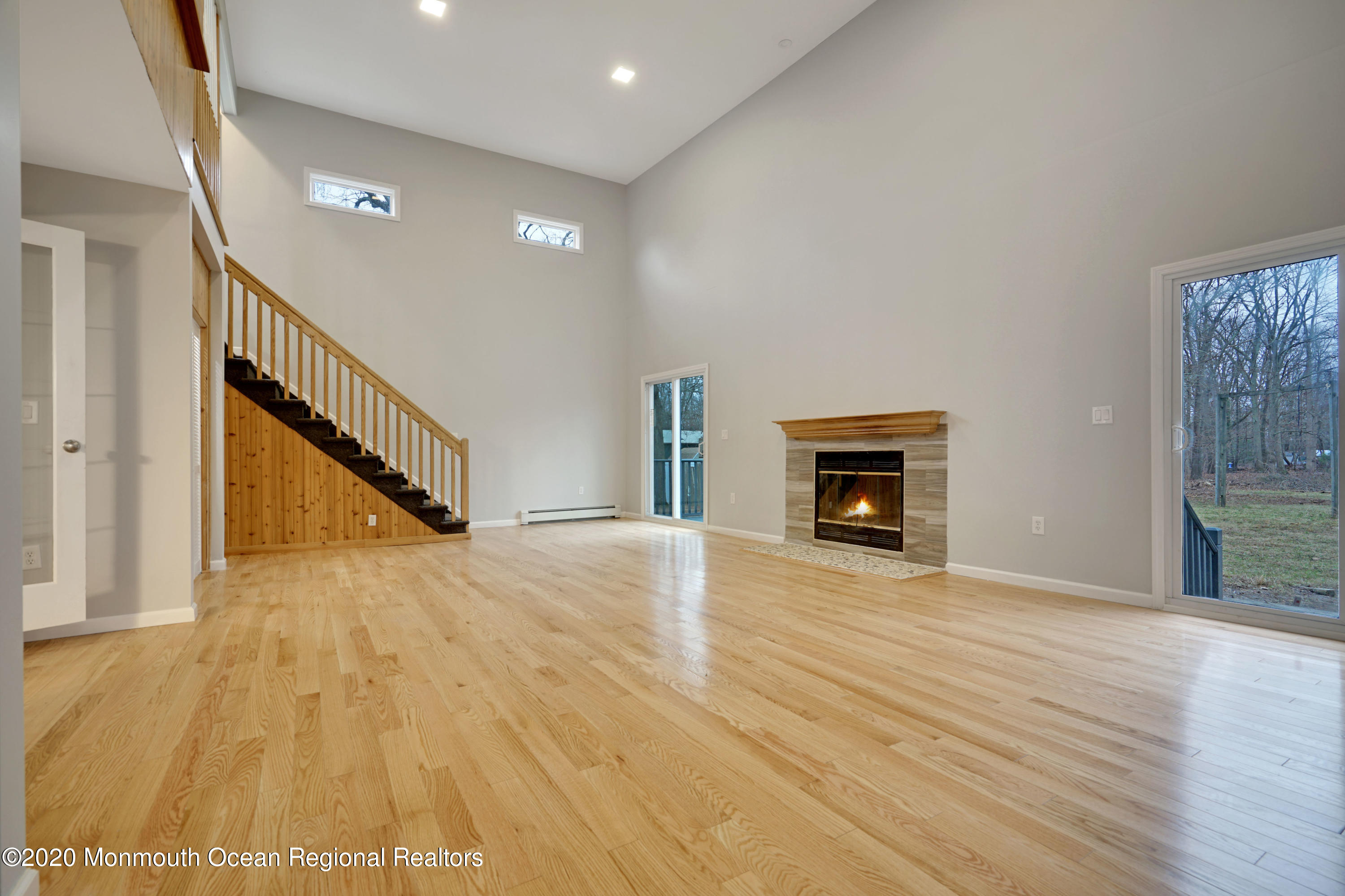 17 Helen Avenue Howell, NJ 07731 - Photo 56 of 67 a view of an empty room with wooden floor fireplace and a window