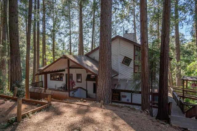 a view of a house with a yard and balcony