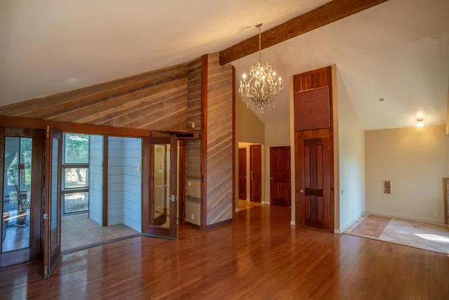 a room with a wooden floor and a window