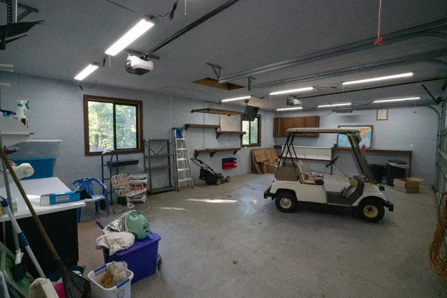 a view of a garage with wooden shelves