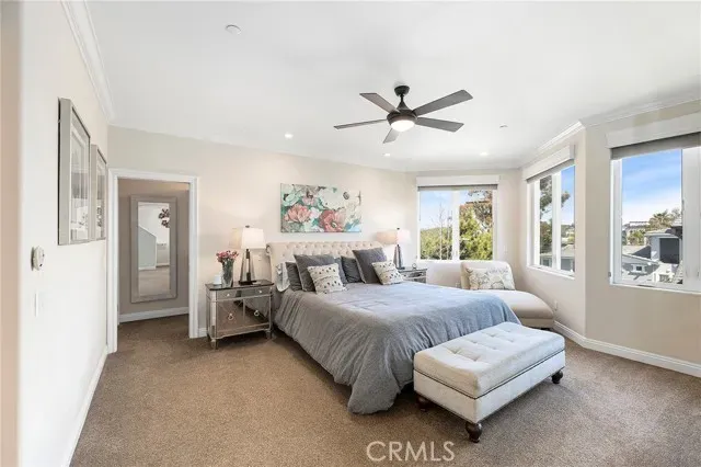 a bedroom with a bed couch and window