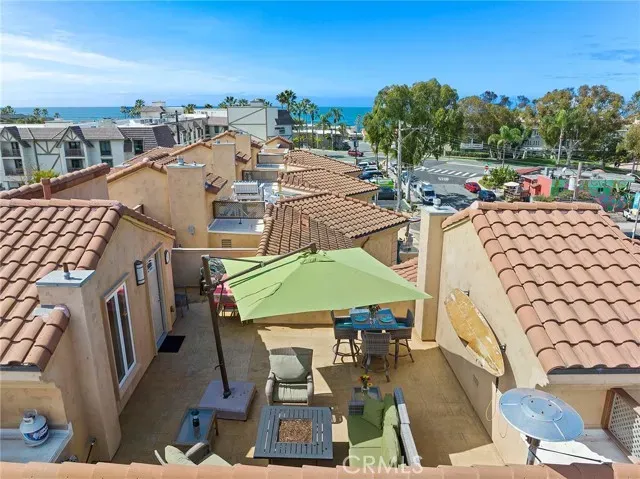 a view of a terrace with lawn chairs