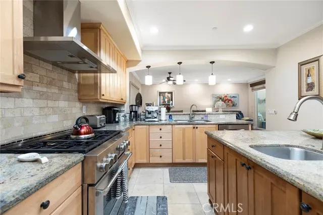 a kitchen with stainless steel appliances granite countertop a sink stove and cabinets