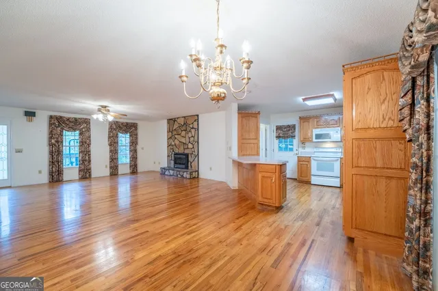 a kitchen with stainless steel appliances granite countertop wooden cabinets a sink and a granite counter tops