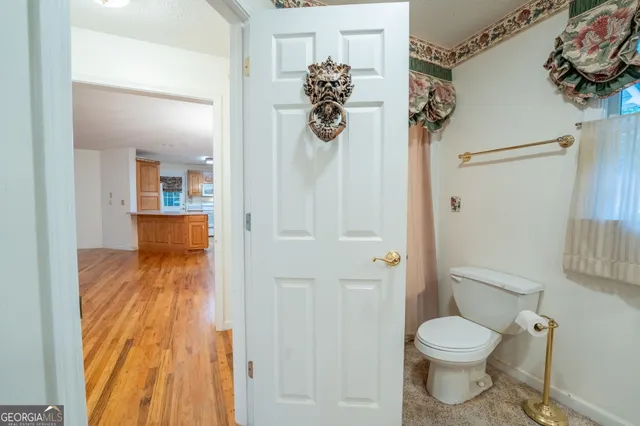 a bathroom with a granite countertop sink a mirror and a shower