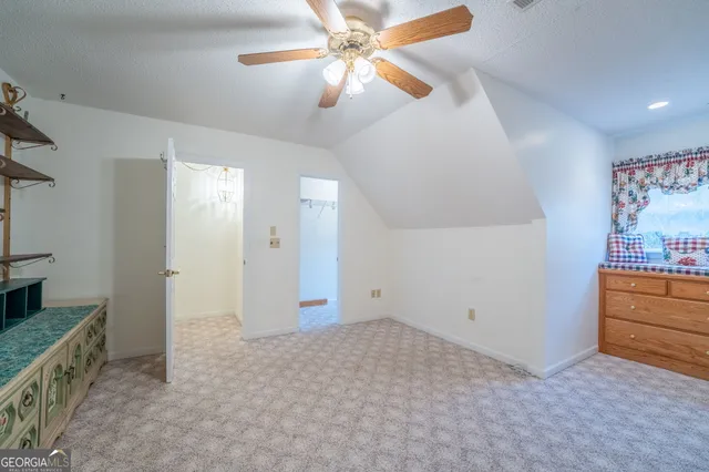 an empty room with closet and windows