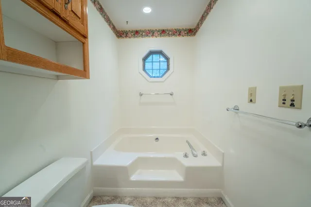 a bedroom with bed and a window