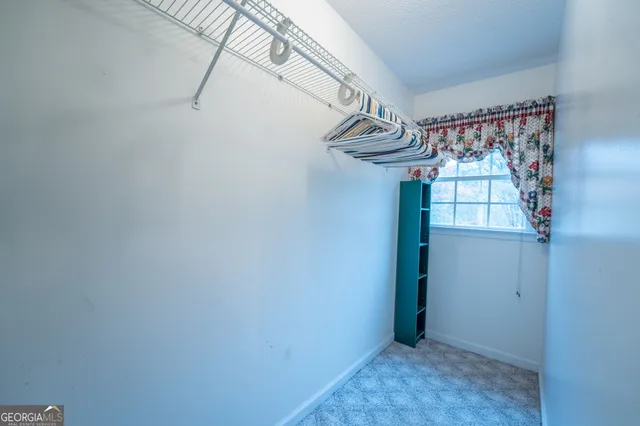 a bedroom with furniture and a lamp