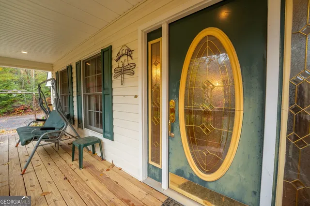 a view of a livingroom with furniture staircase and a kitchen