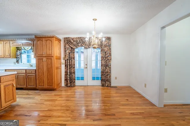 a view of a kitchen with furniture and wooden floor