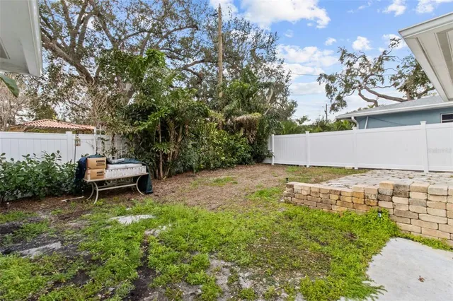 a view of a patio with table and chairs