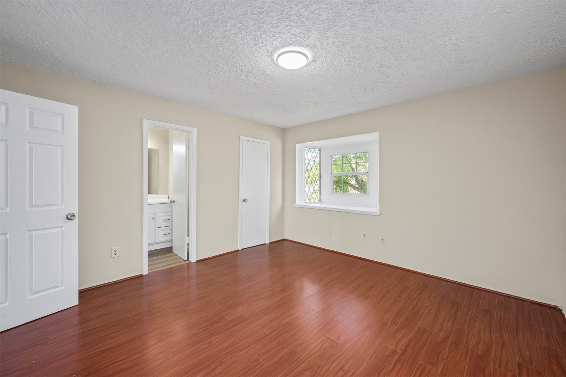 7236 Crownwest Street, Unit 7236 Houston, TX 77072 - Photo 12 of 21 a view of an empty room with wooden floor and a window