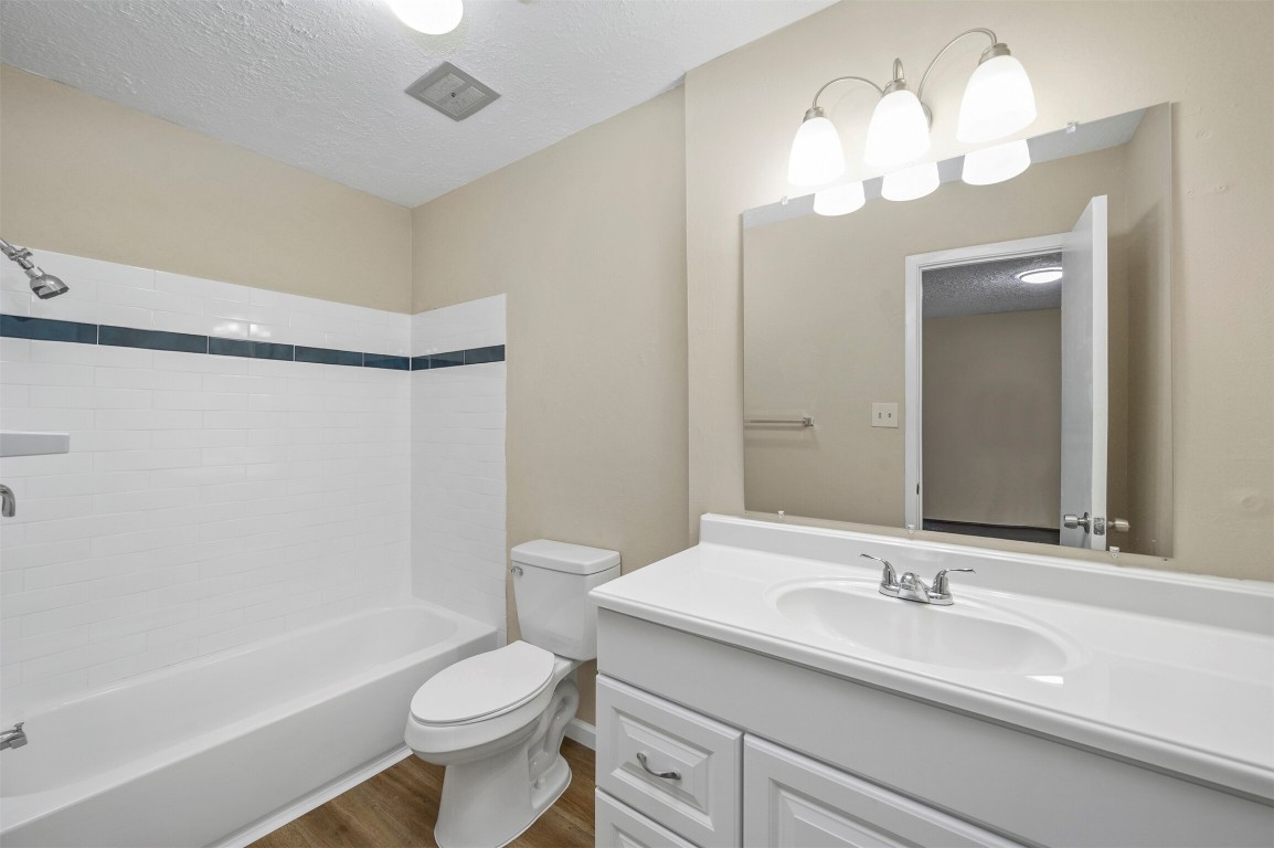 7236 Crownwest Street, Unit 7236 Houston, TX 77072 - Photo 13 of 21 a bathroom with a sink a toilet a mirror a vanity and bathtub