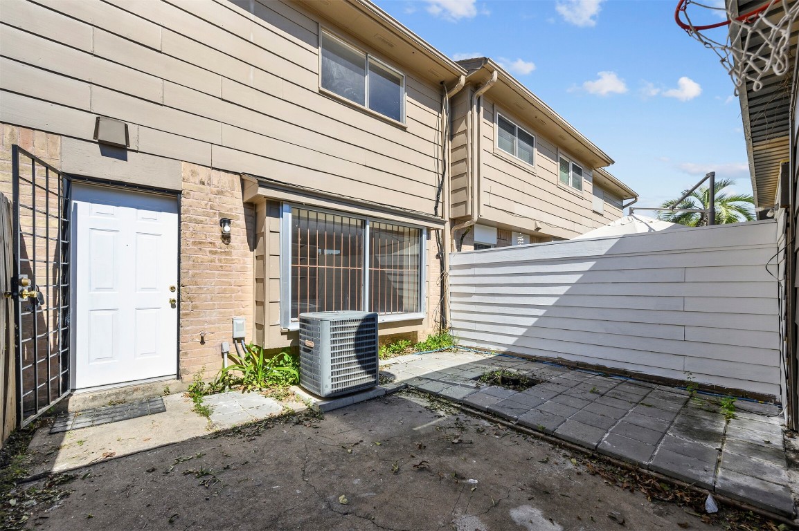 7236 Crownwest Street, Unit 7236 Houston, TX 77072 - Photo 18 of 21 a front view of a house with garden