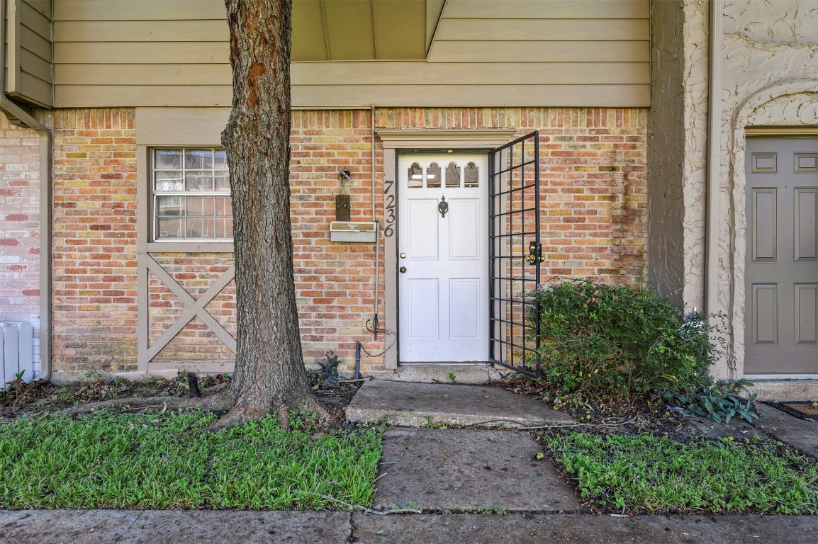 7236 Crownwest Street, Unit 7236 Houston, TX 77072 - Photo 2 of 21 a front view of a house with a garden