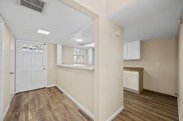 a view of empty room with wooden floor