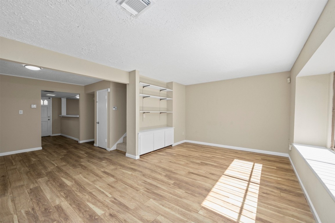 7236 Crownwest Street, Unit 7236 Houston, TX 77072 - Photo 7 of 21 a view of an empty room with wooden floor