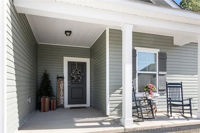 a view of a porch with a door and a large window