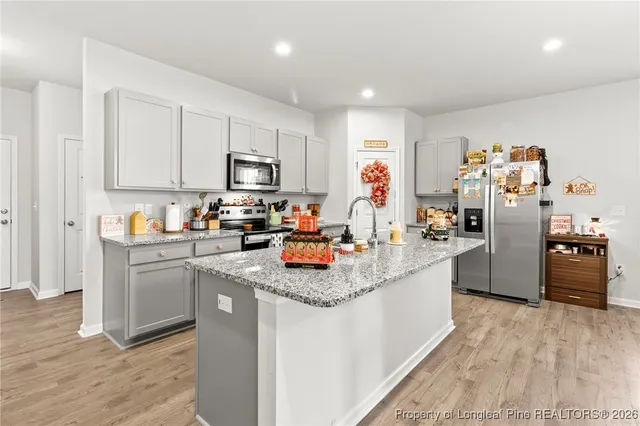 a kitchen with refrigerator and cabinets
