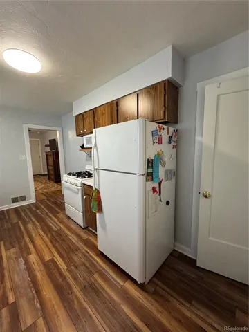 a white refrigerator freezer sitting in a kitchen