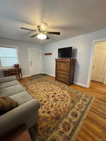 a bedroom with furniture and a flat screen tv