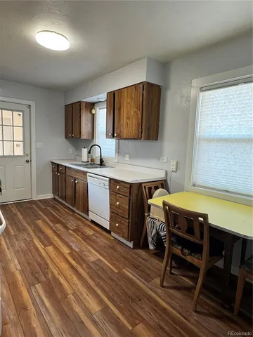 a kitchen with a wooden table and chairs