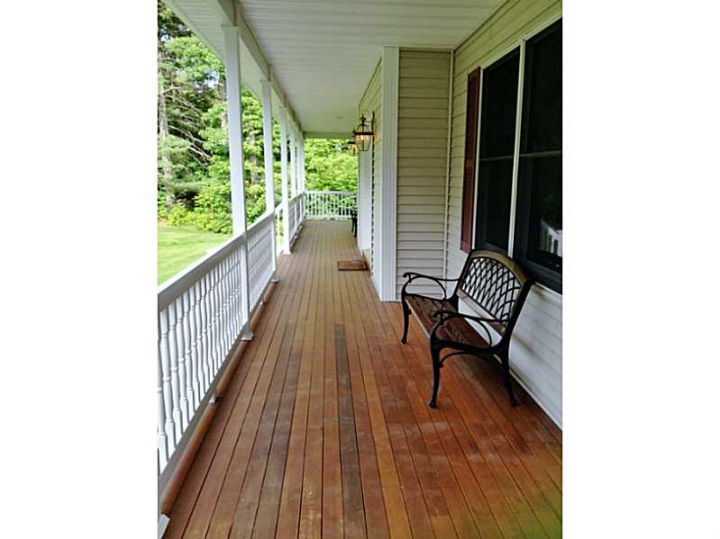 107 Ridge Drive Exeter, RI 02822 - Photo 3 of 24 Porch. Wrap around mahogany porch