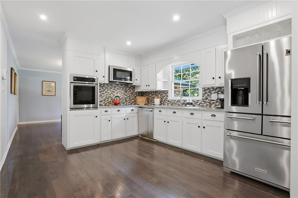 4000 Lower Roswell Road Marietta, GA 30068 - Photo 7 of 25 a kitchen with cabinets stainless steel appliances a sink and wooden floor