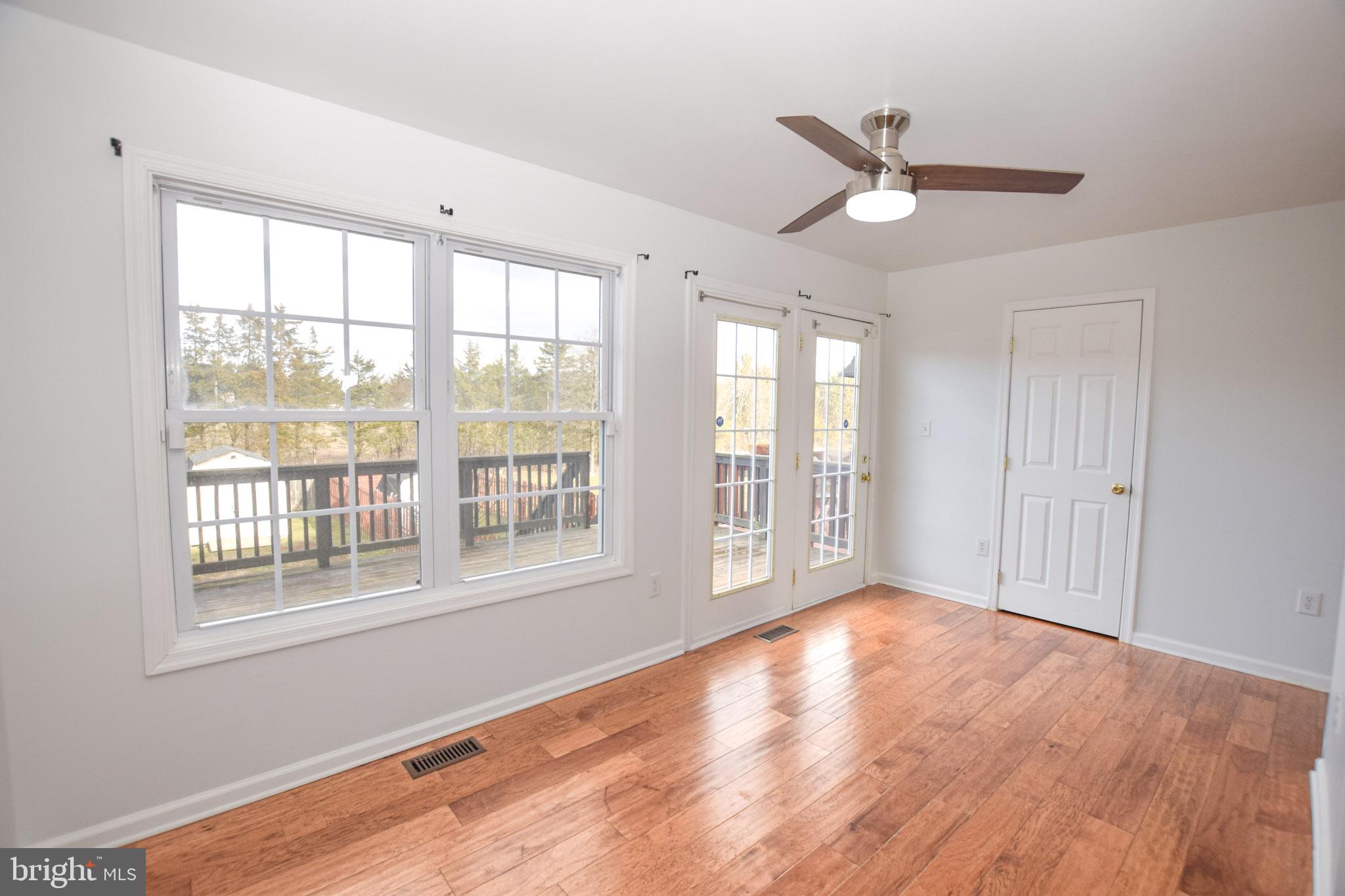 226 Topaz Lane Inwood, WV 25428 - Photo 11 of 32 a view of an empty room with a window and wooden floor