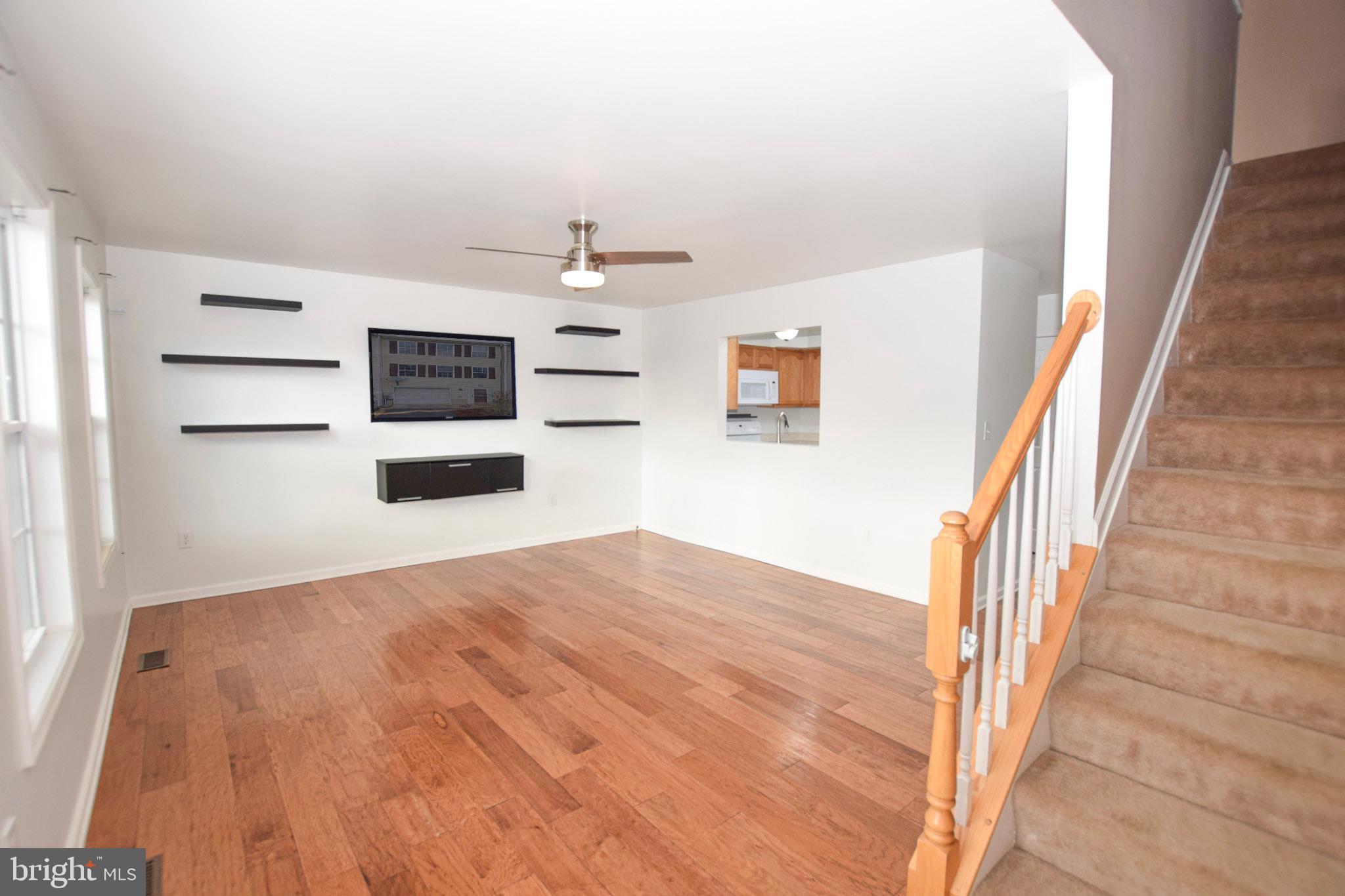 226 Topaz Lane Inwood, WV 25428 - Photo 13 of 32 a view of a livingroom with wooden floor and staircase