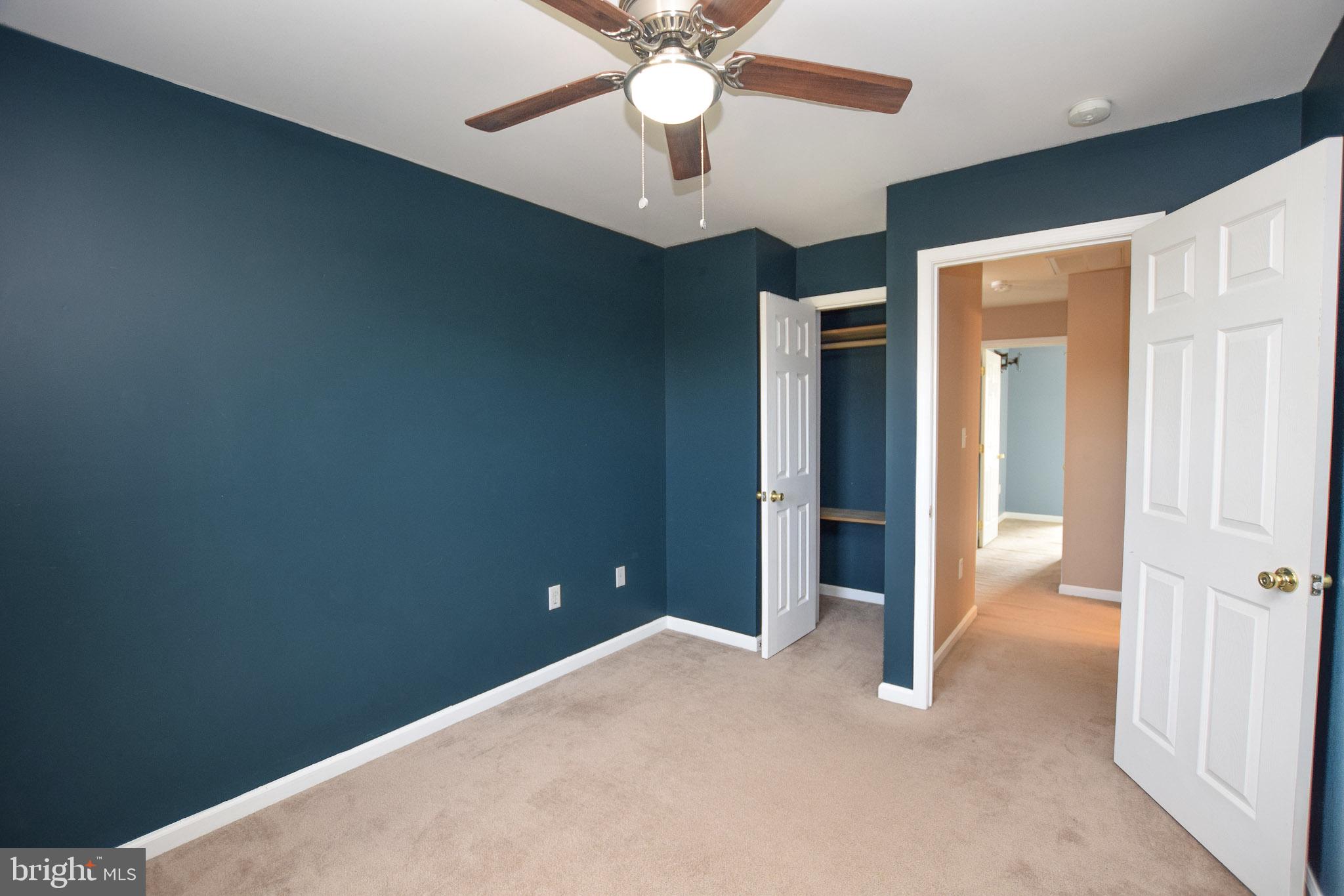 226 Topaz Lane Inwood, WV 25428 - Photo 18 of 32 an empty room with closet and a chandelier fan