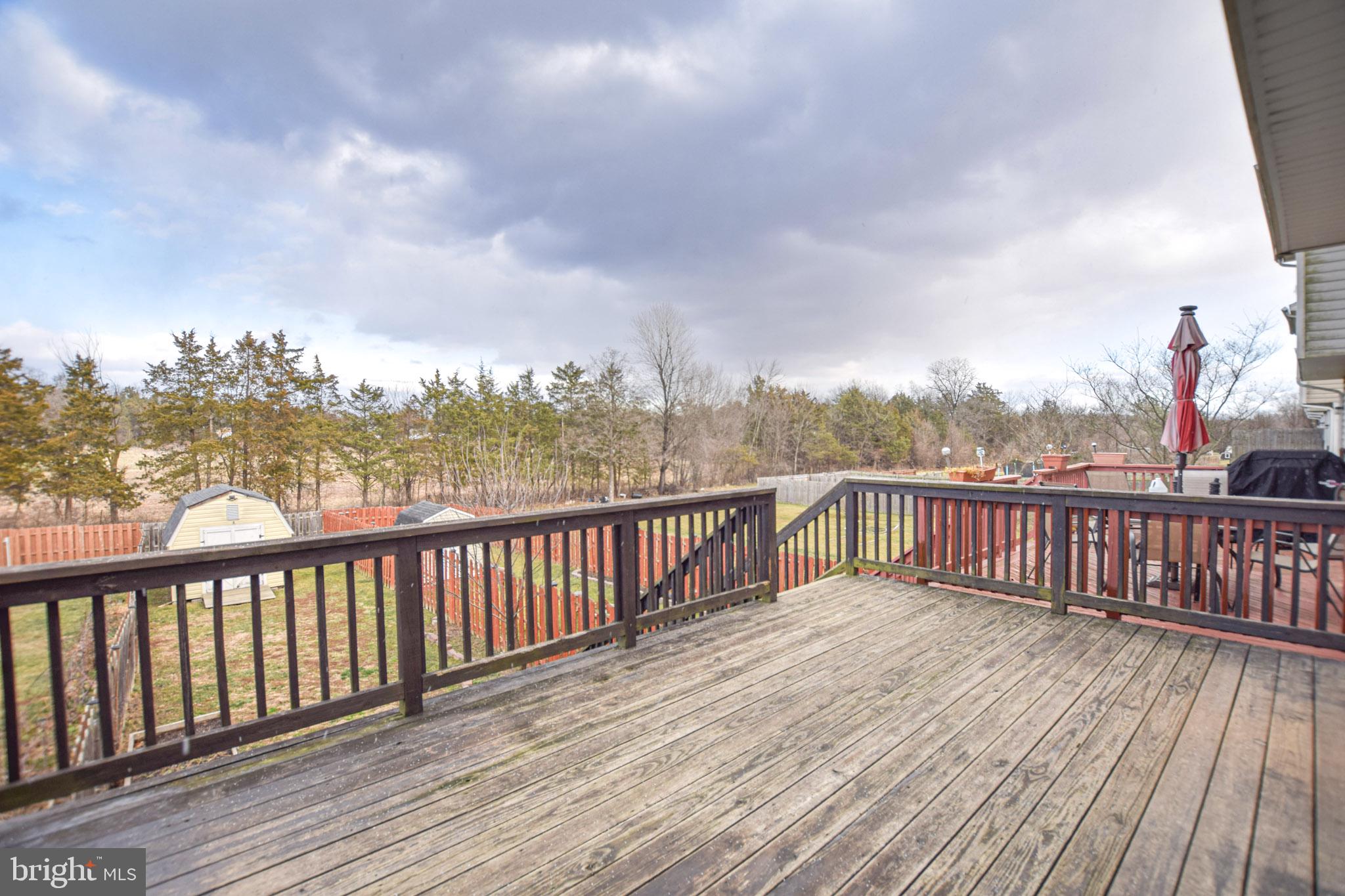 226 Topaz Lane Inwood, WV 25428 - Photo 27 of 32 a balcony with wooden floor and fence