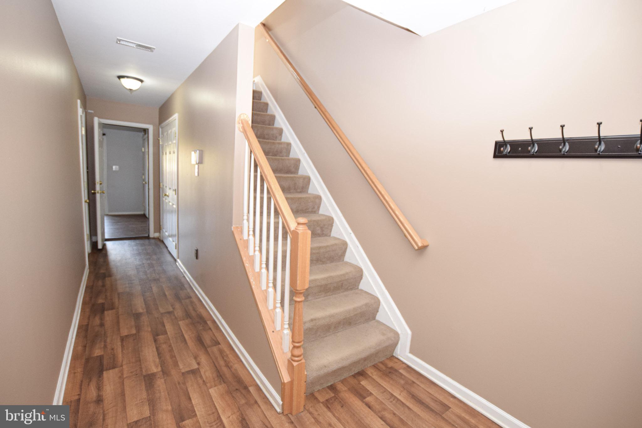 226 Topaz Lane Inwood, WV 25428 - Photo 4 of 32 a view of a hallway with wooden floor and staircase