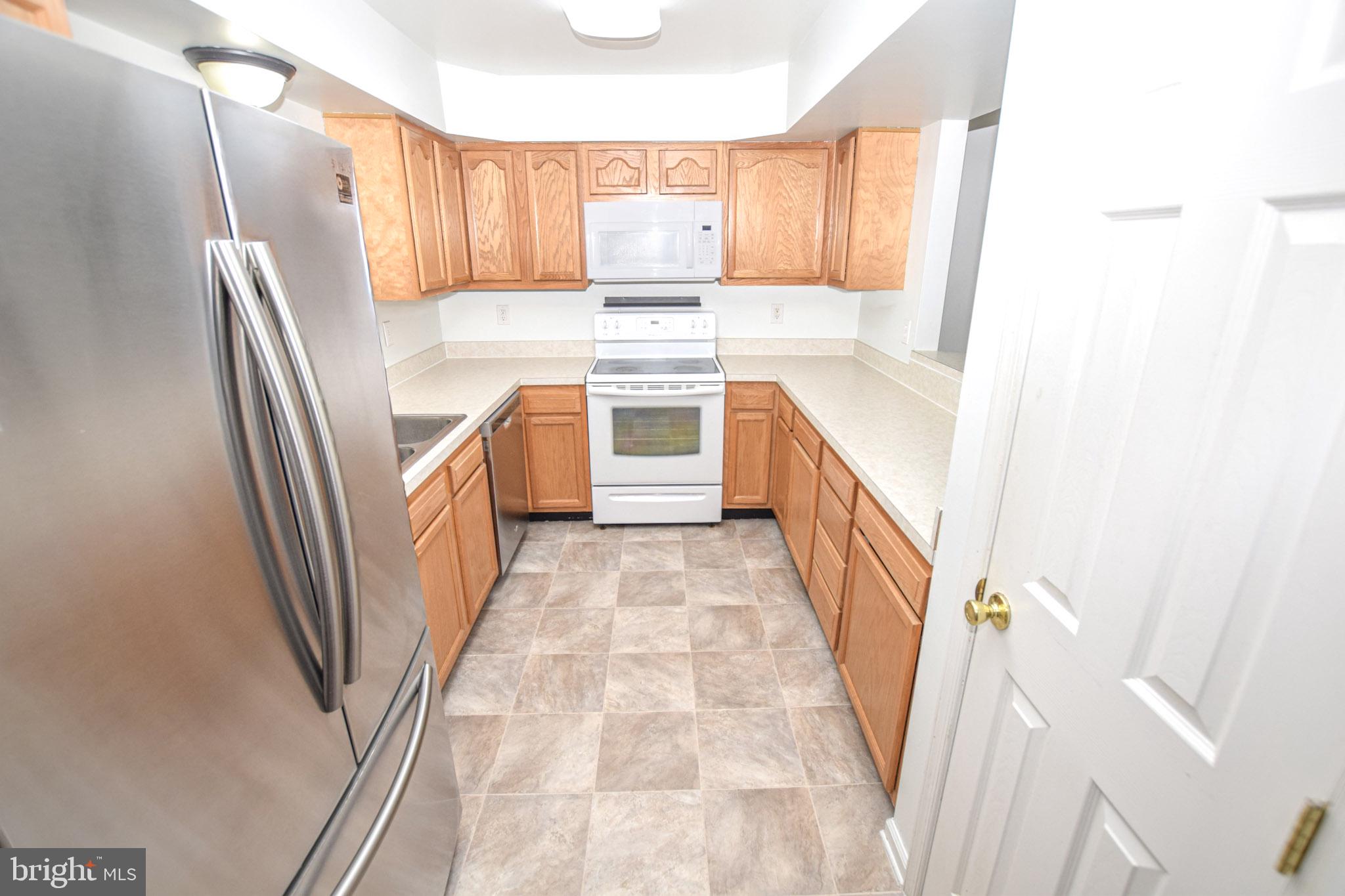 226 Topaz Lane Inwood, WV 25428 - Photo 7 of 32 a kitchen with stainless steel appliances a refrigerator and a stove