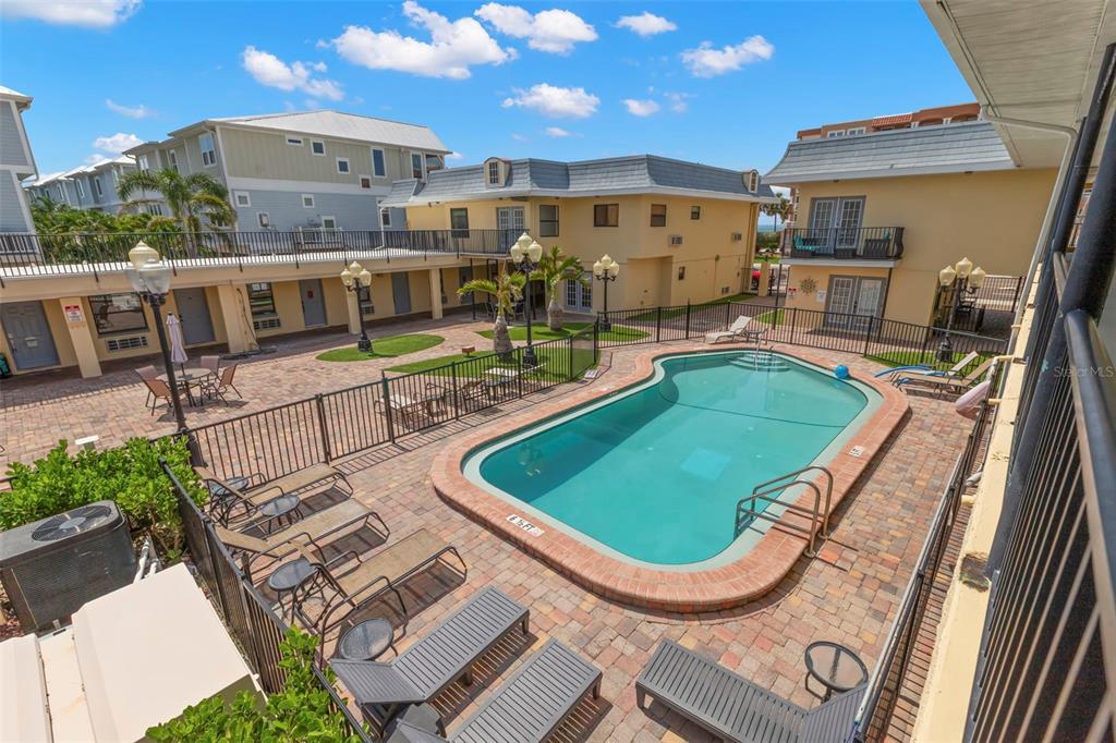 16333 Gulf Boulevard, Unit 113 Redington Beach, FL 33708 - Photo 24 of 40 a view of a swimming pool with a patio