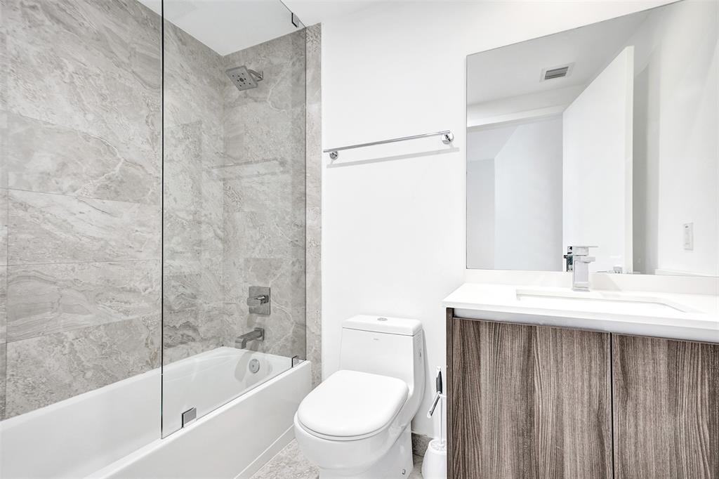 488 Northeast 18th Street, Unit 801 Miami, FL 33132 - Photo 13 of 46 a bathroom with a sink a toilet and shower