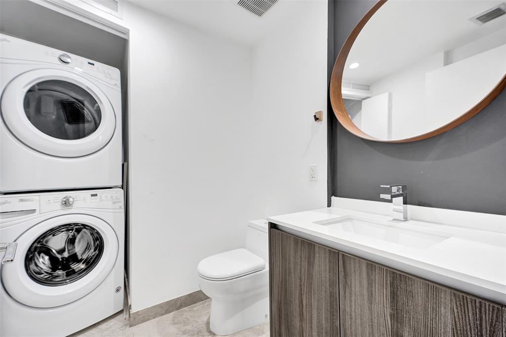 488 Northeast 18th Street, Unit 801 Miami, FL 33132 - Photo 14 of 46 a bathroom with a sink a mirror and toilet