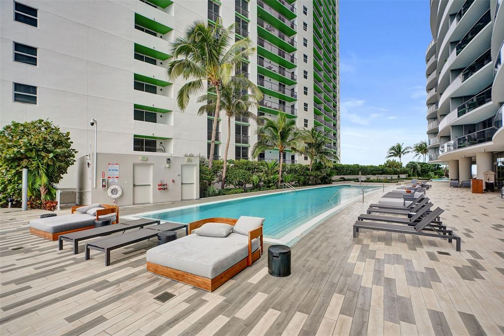 488 Northeast 18th Street, Unit 801 Miami, FL 33132 - Photo 25 of 46 a swimming pool with outdoor seating and yard