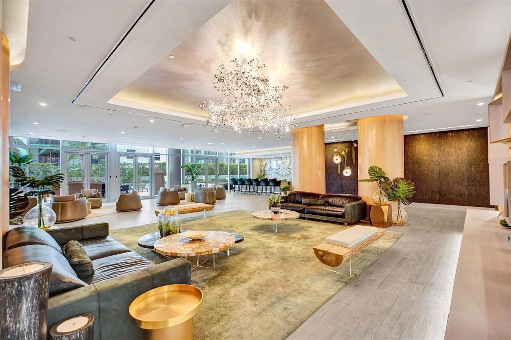 488 Northeast 18th Street, Unit 801 Miami, FL 33132 - Photo 34 of 46 a view of a dining room with furniture a chandelier and large windows